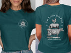 Teal t-shirt with "The Little Red Farm" logo featuring stacked farm animals and text.