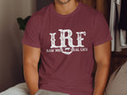 Maroon t-shirt with distressed white text "LRF RAW MILK REAL LIFE" and cow graphic.