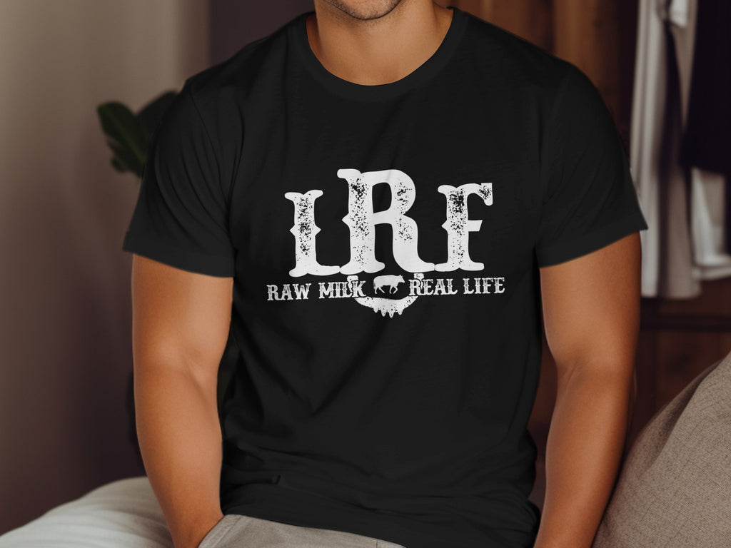 Black t-shirt with white text "LRF Raw Milk Real Life" and a cow silhouette.