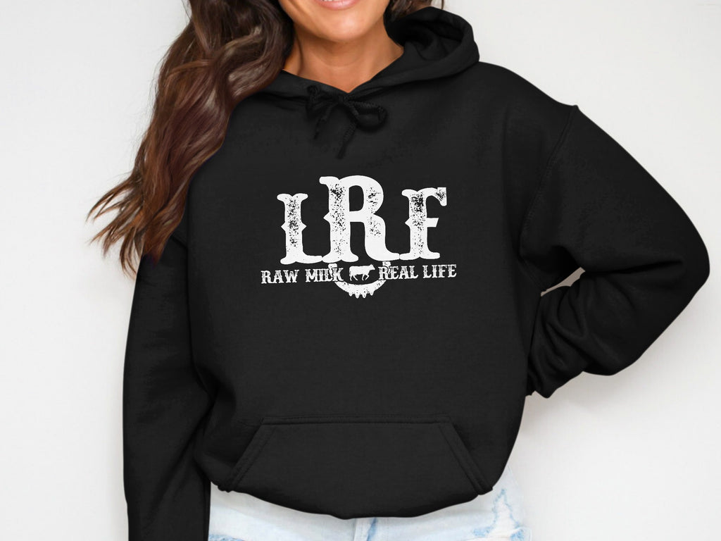 Black hoodie with white text "LRF RAW MILK REAL LIFE" and cow graphic.