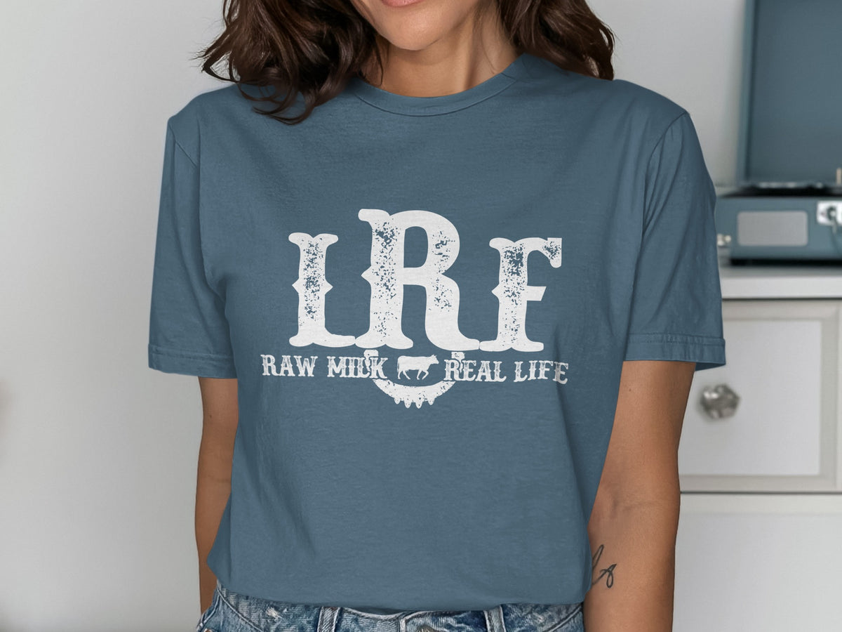 Blue t-shirt with "LRF RAW MILK REAL LIFE" text and a cow silhouette.