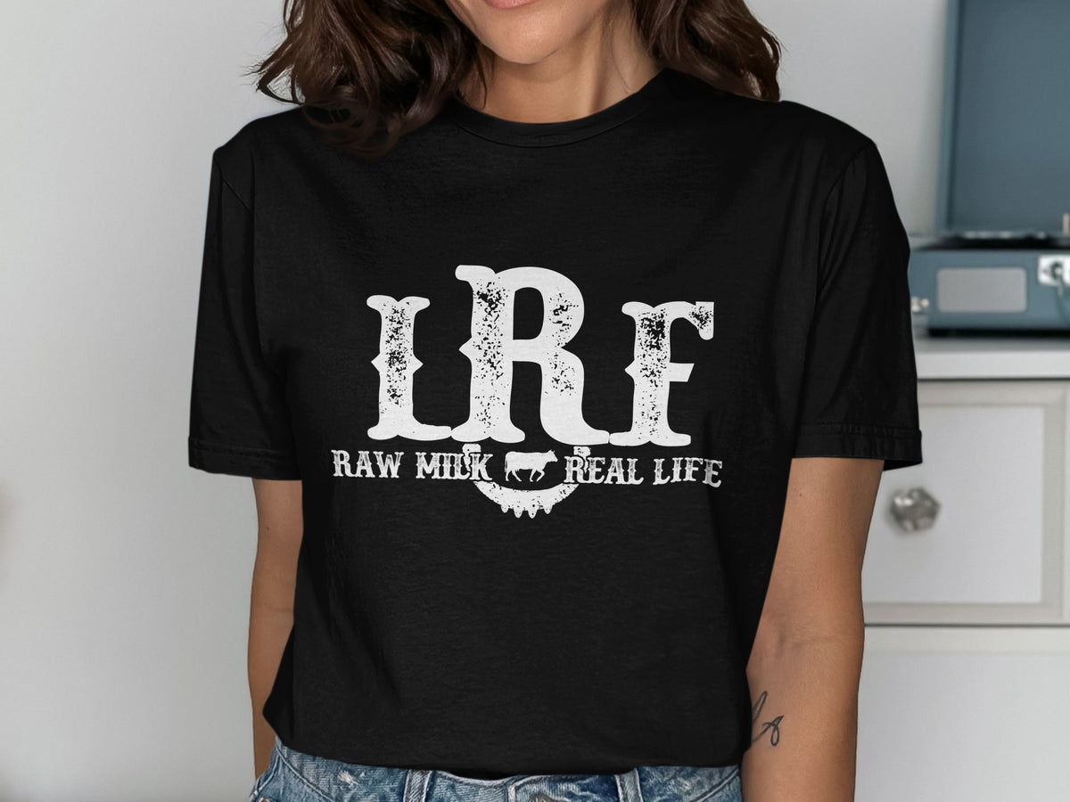 Black t-shirt with white text "IRF" and "RAW MILK REAL LIFE" and cow graphic.